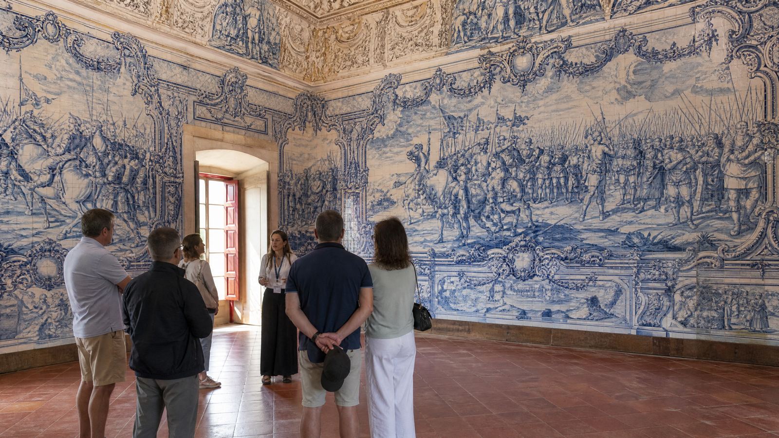 Visitors with a guide in the tiled Battle Room, Fronteira Palace